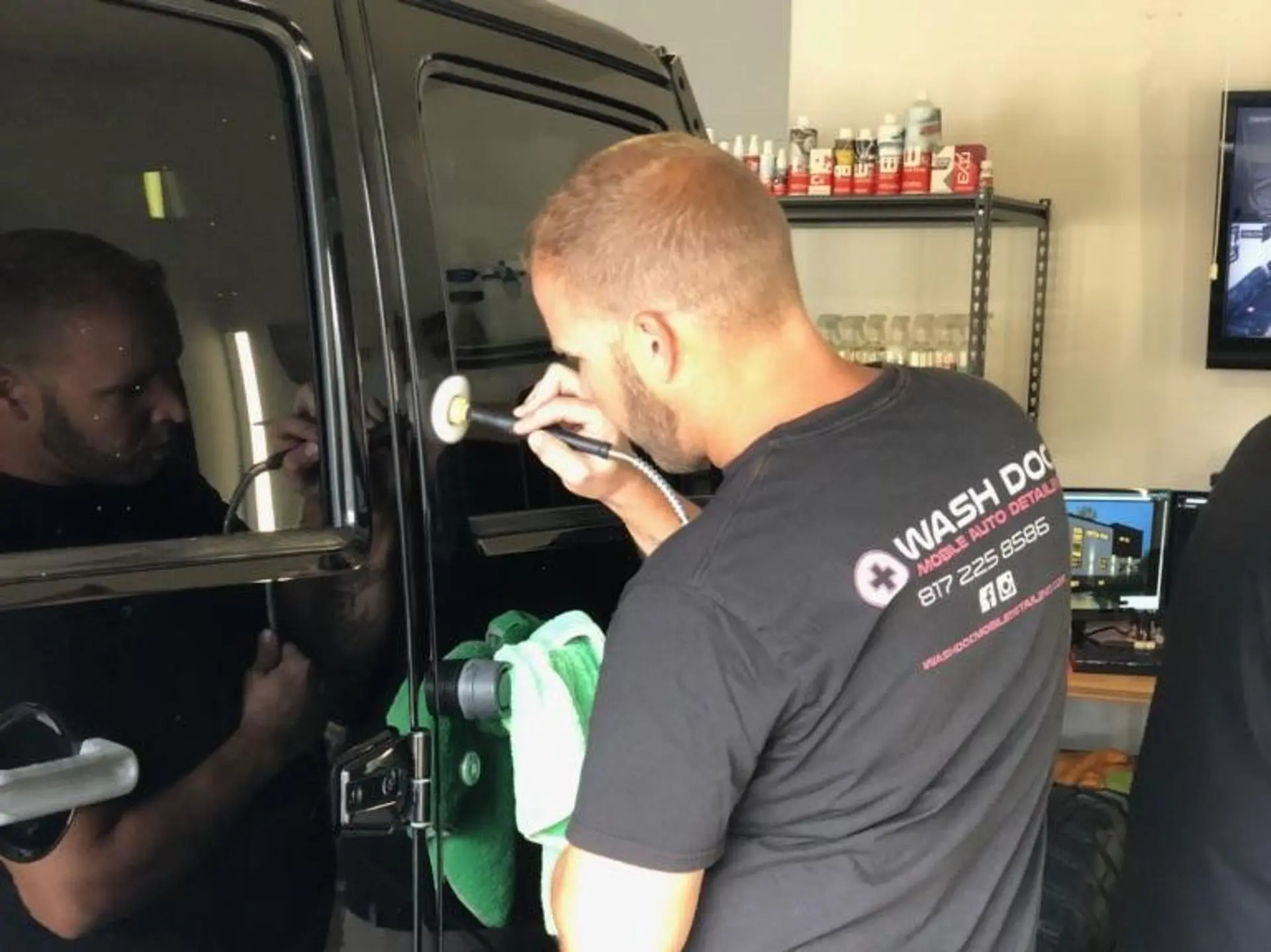 black car applying ceramic coating by expert at wash doc auto detailing haltom city tx